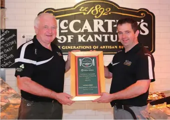  ??  ?? Fifth and sixth generation butchers, Jack and Tim McCarthy, display the award the shop won for its breakfast meats from recognised food writer Georgina Campbell.