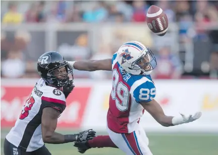  ?? PHOTOS: PAUL CHIASSON/THE CANADIAN PRESS ?? The ball drops out of reach of Alouettes wide receiver Duron Carter as Ottawa Redblacks defensive back Forrest Hightower covers during the Redblacks’ 28-13 win in Montreal on Thursday.