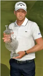  ?? AP PHOTO ?? GRAND PRIZE: Daniel Berger poses with the trophy after his 1-stroke victory in the St. Jude Classic at TPC Southwind in Memphis, Tenn.