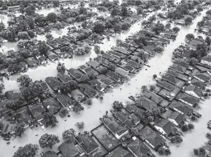  ?? Staff file photo ?? Five years ago, Hurricane Harvey turned streets into rivers in this neighborho­od near Interstate 10. The latest legislatio­n to address such calamities may help turn the tide in favor of emissions controls.