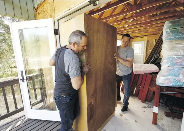 ?? IAN KUCERAK ?? Hope Adventure Centre executive director John-Mark Gal, left, and camp director Pat O’Connor move furniture into a cabin at the Sturgeon County property on Wednesday. The evangelica­l pastors are hoping to open the camp to at-risk youth, but neighbours...