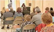  ?? [PHOTO BY CARLA HINTON, THE OKLAHOMAN] ?? A crowd listens as Rachel Pappy, with Polston Tax, reads Scripture during the Celebratio­n of the Bible bible reading event on Tuesday at the state Capitol in Oklahoma City.