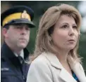  ?? DARRYL DYCK/ THE CANADIAN PRESS ?? Surrey Mayor Dianne Watts and RCMP Cpl. Bert Paquet hold a news conference outside the Newton Arena in Surrey on Monday.