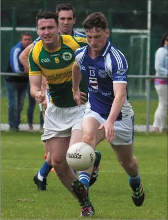  ??  ?? Templenoe’s Stephen O’Sullivan in action with Mike Wrenn, John Mitchels, in last Sunday’s County Senior Football League Division 1 match at John Mitchels GAA Club, Tralee