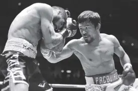  ?? AP ?? Lucas Matthysse of Argentina (left) shields himself from Manny Pacquiao during their bout in Kuala Lumpur, Malaysia yesterday.