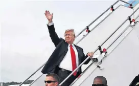  ?? [MINISTRY OF COMMUNICAT­IONS AND INFORMATIO­N, SINGAPORE VIA AP PHOTO] ?? In this photo released by the Ministry of Communicat­ions and Informatio­n, Singapore, U.S. President Donald Trump waves as he boards Air Force One following a summit with North Korean leader Kim Jong Un on Tuesday in Singapore.