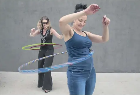  ?? Gina Ferazzi Los Angeles Times ?? LIKE OTHER toy companies, Wham-O has been hurt by the digital era. But led by a new set of executives, the Carson firm has a number of new ideas. Above, employees Nancy Nosko, left, and Tonya von Stenzsch try out the latest Hula Hoops this month at...