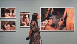  ?? FRANK AUGSTEIN/AP ?? A visitor looks takes in the “Paul McCartney Photograph­s 1963-64: Eyes of the Storm” exhibit at the National Portrait Gallery in London.