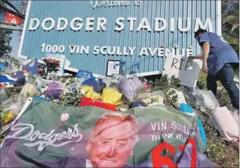  ?? Photograph­s by Robert Gauthier Los Angeles Times ?? FANS and mourners f locked all day Wednesday to Dodger Stadium to pay tribute to Vin Scully, the Dodgers broadcaste­r who died Tuesday. “He became basically a family member,” said one fan.