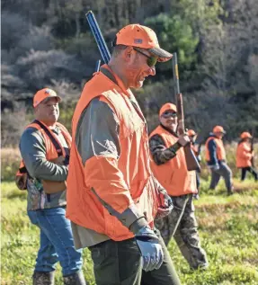  ?? THE BRAND AMP ?? Joe Thomas, foreground, shares stories with military veterans Mark Schroeder, left, and James Ardle while pheasant hunting during the Heroes Hunt last month at LEEK Hunting &amp; Mountain Preserve in Pennsylvan­ia.
