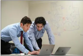  ?? (AP/Star Tribune/Aaron Lavinsky) ?? Minneapoli­s Mayor Jacob Frey (left) confers with deputy campaign manager Jacob Hill on Tuesday at Frey’s campaign headquarte­rs in Minneapoli­s. Frey was in a tough fight to win a second term.