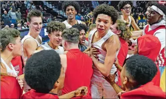  ?? SEAN D. ELLIOT/THE DAY ?? NFA players celebrate their 54-43 win over Ledyard in Tuesday night’s ECC Division I boys’ basketball championsh­ip game at Mohegan Sun Arena.