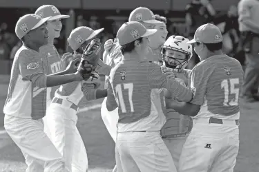  ?? Associated Press ?? n Texas catcher Chandler Spencer, second from right, begins to celebrate with Mark Requena (15) and Collin Ross (17) after getting the final out of a 6-5 win over North Carolina in the United States Championsh­ip baseball game Saturday at the Little...