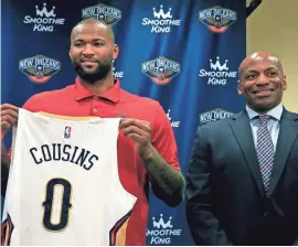  ?? TED JACKSON /NOLA.COM THE TIMES-PICAYUNE VIA AP ?? DeMarcus Cousins holds his new jersey with Pelicans general manager Dell Demps during a news conference Wednesday in Metairie, La.