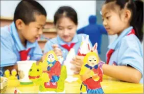  ?? PHOTOS BY ZHANG HAIBIN AND DING GENHOU / FOR CHINA DAILY ?? Lanterns (left) and Tu’er Ye (the rabbit god) figurines (above) are popular with children during Mid-Autumn Festival.