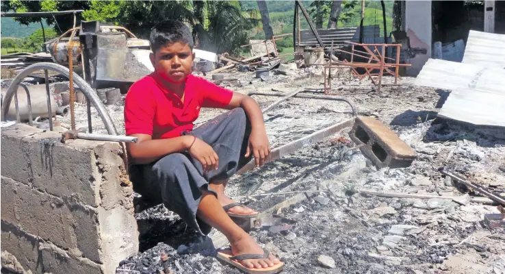  ?? Photo: Charles Chambers ?? Shivnesh Kumar sits on what was left of his home in Nadele, Sabeto, Nadi.