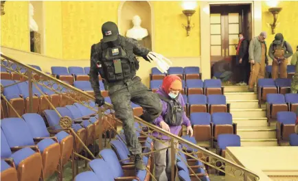  ?? WIN MCNAMEE/GETTY IMAGES ?? Protesters enter the Senate Chamber of the Capitol in Washington, D.C., on Wednesday.