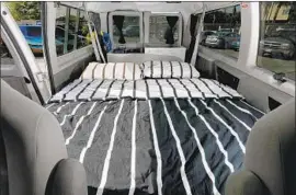  ??  ?? A CAMPER van at Escape Campervans in Inglewood has a queen-size bed that converts into a table and seats. Escape is the largest U.S. camper van rental business.