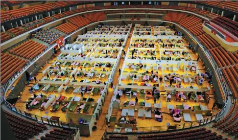  ?? ZHU XINGXIN / CHINA DAILY ?? COVID-19 patients and medical workers live in a makeshift hospital inside the Wuhan Sports Center in Wuhan, capital of central China’s Hubei province, on March 2.