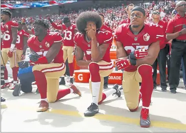  ?? NHAT V. MEYER — STAFF ARCHIVES ?? From left to right, San Francisco 49ers’ Eli Harold, quarterbac­k Colin Kaepernick and Eric Reid kneel during the national anthem before their NFL game against the Dallas Cowboys at Levi’s Stadium on Oct. 2, 2016.