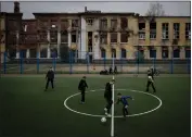  ?? ?? Youths play soccer this month at a school that once quartered Russian soldiers before they were repulsed from the city in Kharkiv, Ukraine.