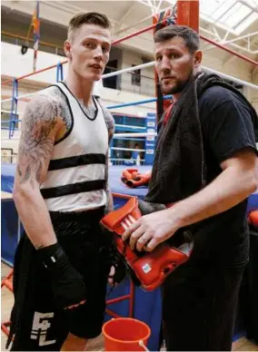  ??  ?? BOXING LABORATORY: Mark Reigate [left, holding head guard] follows in the footsteps of Mick Carney [far left] who once turned down a plea from Lennox Lewis [top]