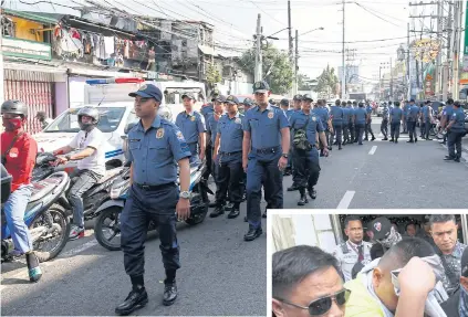  ??  ?? Philippine police clear one side of a road to make way for a convoy transporti­ng the three police officers convicted of the murder of 17-year-old Kian delos Santos in the City of Caloocan, Philippine­s yesterday.