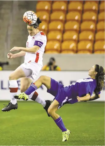  ?? David J. Phillip / Associated Press ?? Rhian Wilkinson has no trouble getting off a header over Guatemala’s Daniela Andrade during Canada’s 10-0 victory Tuesday night at BBVA Compass Stadium that continued the dominance of the Canadians and Americans in the Olympic qualifying tournament.