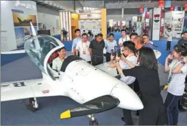  ?? XU CHUANBAO / XINHUA ?? Visitors admire a domestical­ly manufactur­ed aircraft during the 3rd RCEP (Shandong) Import Expo in Linyi, Shandong province, on Aug 18.