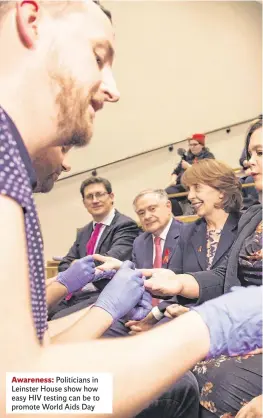  ??  ?? Awareness: Politician­s in Leinster House show how easy HIV testing can be to promote World Aids Day