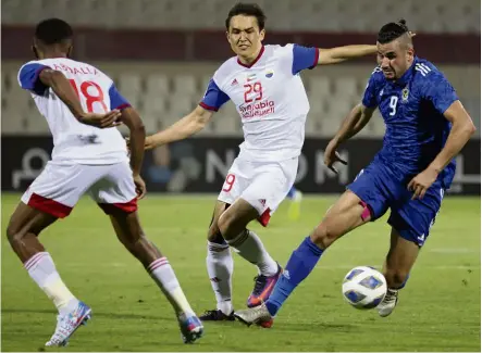  ?? — AFP ?? Tricky situation: Air Force Club’s Ayman Hussein (right) is marked by Sharjah’s Otabek Shukurov (centre) during the AFC Champions League Group B match.