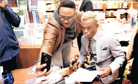  ?? PICTURE: NOKUTHULA MBATHA ?? SNAP: Brian Themba, who inspired Somizi Mhlongo’s book title, Dominoes: Unbreakabl­e Spirit, takes a selfie during the book launch at the Hyde Park Exclusive Books.