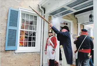  ?? METROLAND FILE PHOTO ?? Barry Coutts, who, with his wife, Linda, donated Nelles Manor to the Grimsby community, takes a moment to shoot a musket following the grand opening celebratio­ns in 2016 while re-enactor Phil Conklin keeps a close watch.