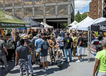  ?? Michael M. Santiago/Post-Gazette ?? Attendees talk and visit vendors at the Fresh Fest black beer festival on Saturday at Nova Place on the North Side.