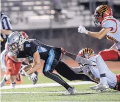  ?? ROBERTO E. ROSALES/JOURNAL ?? Storm WR Justin Ainsworth, left, pulls away from Centennial’s Quevin Redding, bottom right, to score a TD in the second quarter Friday at Cleveland.