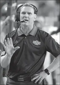  ?? AP/NATI HARNIK ?? Arkansas State Coach Blake Anderson talks on his headset during the second half of the Sept. 2 game against Nebraska in Lincoln, Neb. Anderson, who took over play-calling duties this season, accepted the blame for the last intercepti­on of Saturday’s...