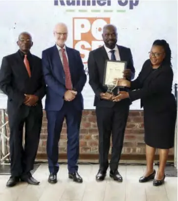  ?? ?? POSB representa­tive Lawrence Kupika (second right) receives the Financial Inclusion award.