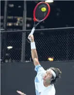  ?? ?? Chinese player Zhang Zhizhen serves in the men’s singles second round match during Australian Open in Melbourne on January 18, 2024.