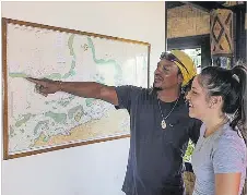  ?? Picture: SUPPLIED ?? Leone and Lara Vokai study a map of the Great Sea Reef at Nukubati Private Island Resort in Macuata. The Leadership Fiji alumni say protecting Fiji’s marine ecosystems requires long-term stewardshi­p, community involvemen­t and leadership that prioritise­s future generation­s.