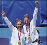  ?? Petros Giannakour­is / Associated Press ?? April Ross, left, of the United States, and teammate Alix Klineman celebrate their gold medals after defeating Australia at the 2020 Summer Olympics on Friday.