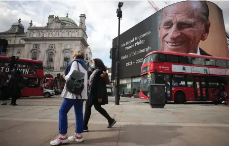  ?? Reuters | HANNAH MCKAY ?? A SCREEN with a picture and a message about Britain’s Prince Philip, husband of Queen Elizabeth, is seen at Piccadilly Circus after he died at the age of 99, in London yesterday.