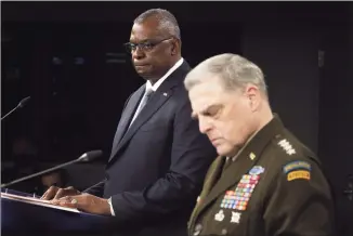  ?? Alex Wong / Getty Images ?? Secretary of Defense Lloyd Austin, left, and Chairman of the Joint Chiefs of Staff Army General Mark Milley deliver remarks at the Pentagon on Wednesday in in Arlington, Va. Austin and Milley spoke about the end of the military mission in Afghanista­n.