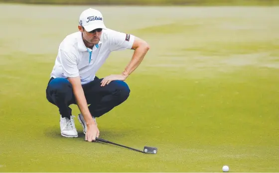  ?? Picture: AAP IMAGE ?? Gold Coast profession­al Michael Sim lines up a putt yesterday at Royal Pines.