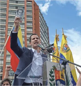  ?? FEDERICO PARRA/AFP/GETTY IMAGES ?? Venezuela’s National Assembly leader Juan Guaido declares himself the country’s “acting president” Wednesday. Venezuelan­s demanded that President Nicolas Maduro step down.