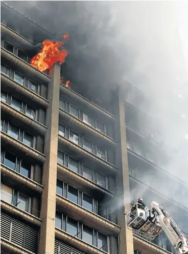  ?? /Sandile Ndlovu/Sowetan ?? Same storey: While a fire at the Bank of Lisbon in Johannesbu­rg devastated offices of the health department, a different form of gutting is taking place across the department’s facilities, as jobs are frozen and waiting lists grow.