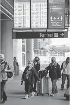  ?? JOSIE NORRIS/ USA TODAY NETWORK ?? Travelers enter a parking garage at Nashville Internatio­nal Airport last month in Nashville, Tenn. The airport is busier now with travelers than at any time since the COVID- 19 outbreak.