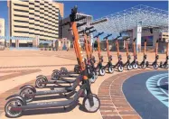  ?? JESSICA DYER/JOURNAL ?? Boston-based Zagster rolled out a fleet of 250 Spinbrande­d e-scooters in Albuquerqu­e on Friday.