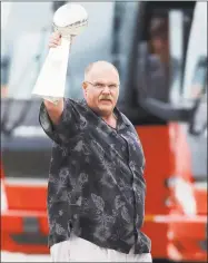  ?? Colin E. Braley / Associated Press ?? Kansas City Chiefs head coach Andy Reid holds up the Vince Lombardi Trophy as his team returns home a day after winning the Super Bowl.