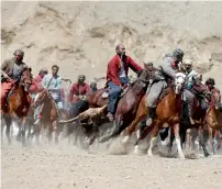  ?? Reuters ?? Afghan horsemen compete during a Buzkashi game in Panjshir province. —