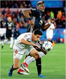  ?? EPA ?? Fall guy: Jesus Navas dives in the United penalty area after Pogba challenges Sevilla’s former Manchester City winger